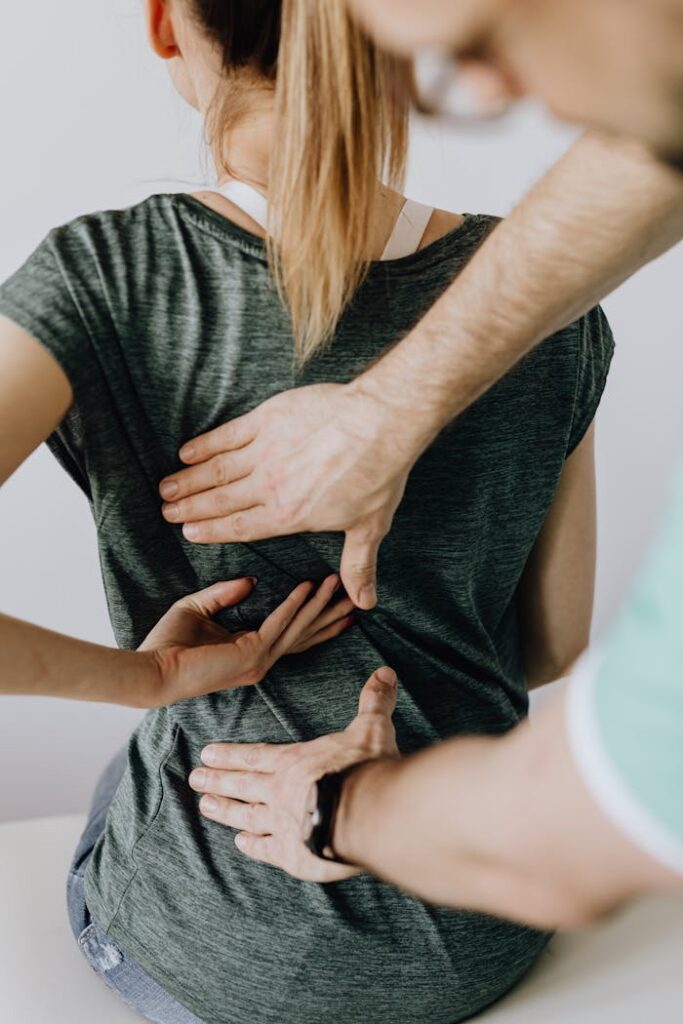 Chiropractor performs manual adjustment on a patient's back to alleviate discomfort and improve posture.